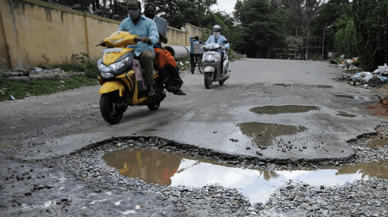 Motorists navigate a pothole at Shanthinagar.Credit: DH file photo