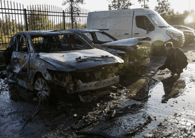 [A police officer works near damaged vehicles at the site of a residential building damaged during a Russian drone and missile strike, amid Russia's attack on Ukraine, in the outskirts of Kyiv, Ukraine, September 20, 2025. REUTERS/Alina Smutko Purchase Licensing Rights