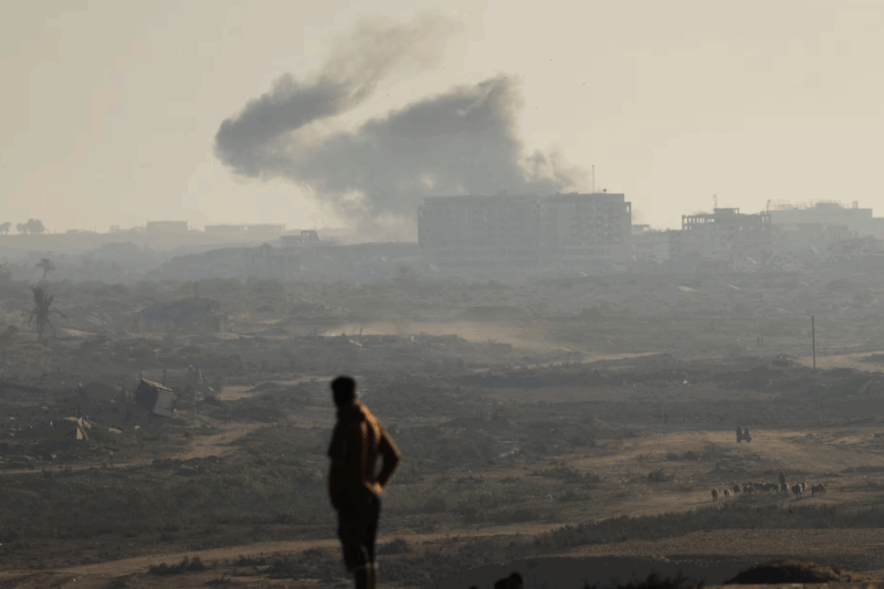 A man looks at smoke rising from an Israeli strike amid an Israeli operation, as seen from central Gaza Strip, September 20, 2025. REUTERS/Dawoud Abu Alkas Purchase Licensing Rights
