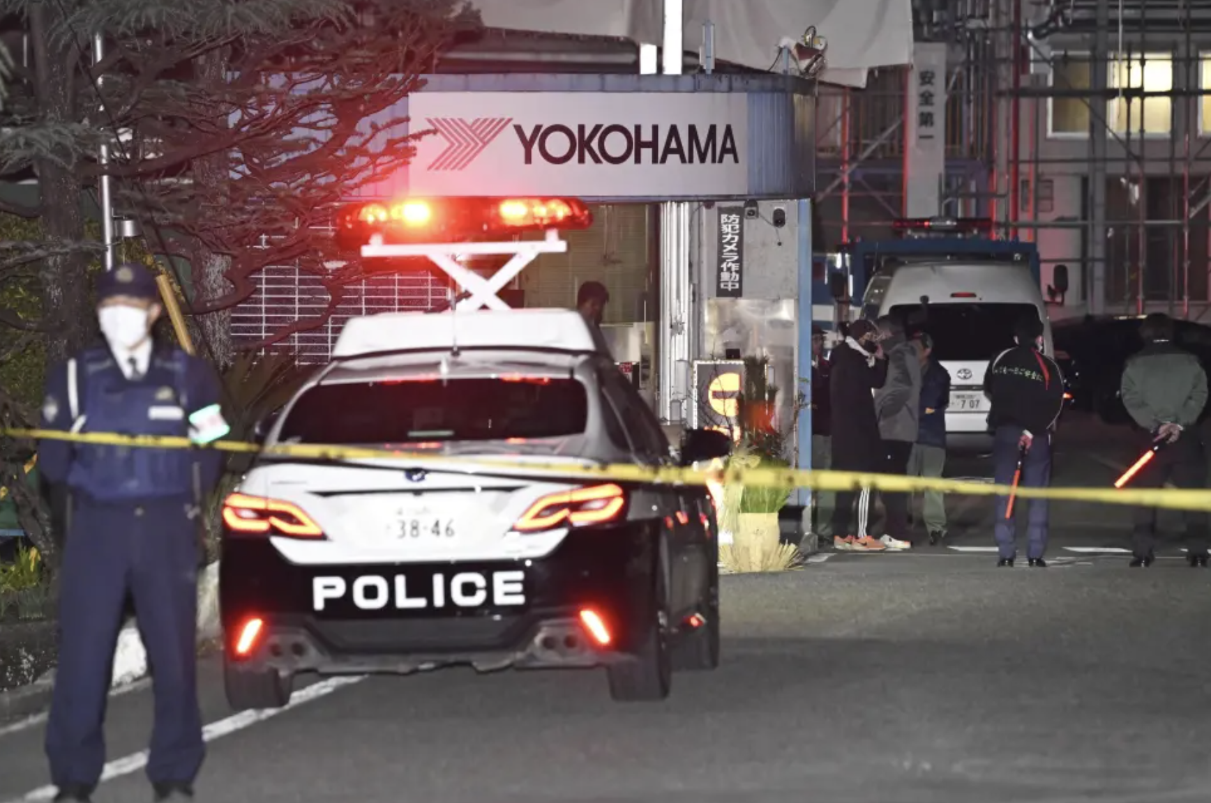 Police officers stand guard at the scene of a stabbing at the Yokohama Rubber Company in Mishima, west of Tokyo, Friday, Dec. 26, 2025. (Yusuke Hashizume/Kyodo News via AP)
